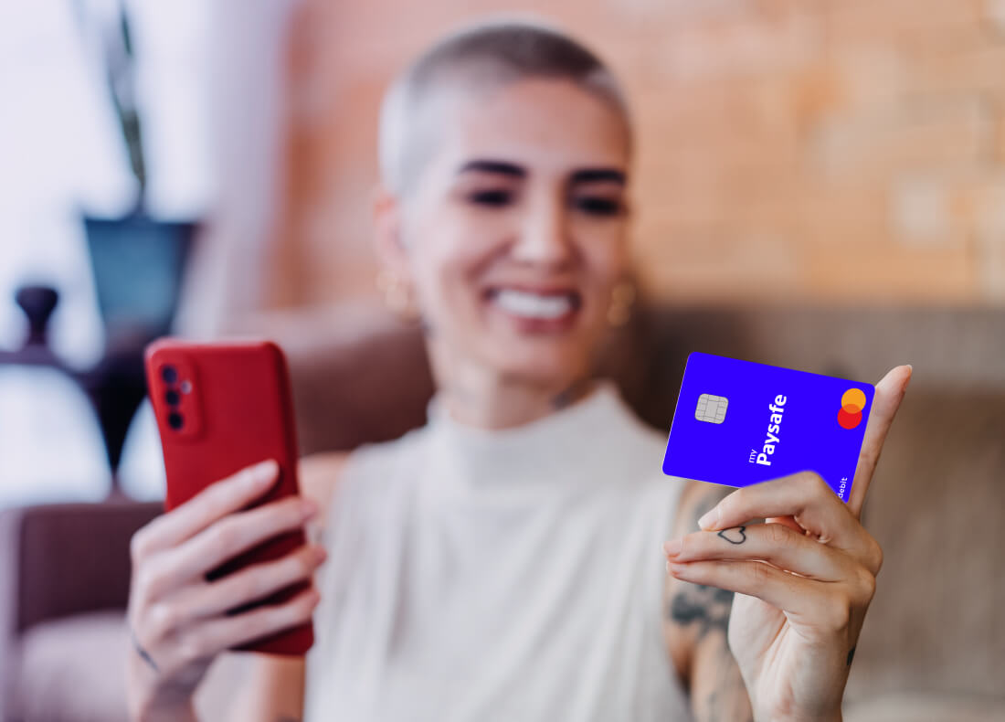 Person smiling and paying with their paysafe card
