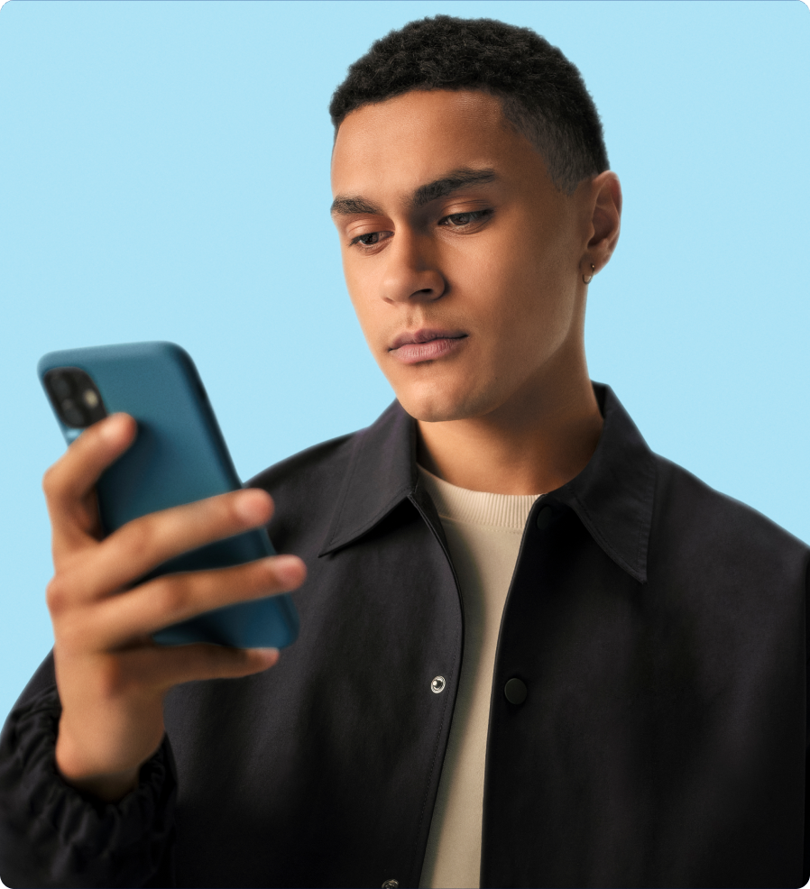 Man in black looking at his smartphone